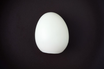 The boiled egg isolated on black plate with space for copy.