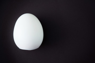 The boiled egg isolated on black plate with space for copy.