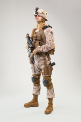 Studio shoot of modern infantry soldier, U.S. marine rifleman in combat uniform, helmet and body armor