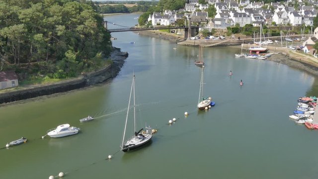 boat sailing  and people Paddleboarding in the delta of Bono, Brittany