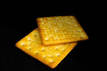 Cracker cookies on dark background.