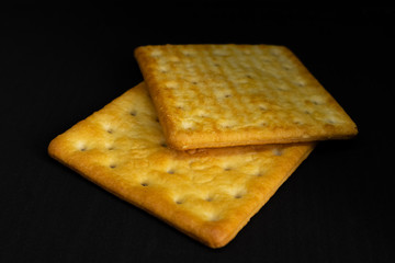 Cracker cookies on dark background.