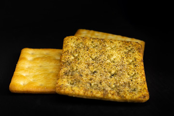 Cracker cookies on dark background.
