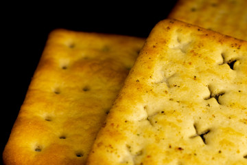 Cracker cookies on dark background.