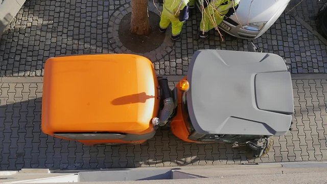 Sweeper street machine cleaning the sidewalks, in slow motion