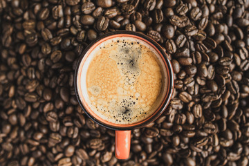 top view cup of coffee espresso on beans background