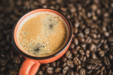 top view cup of coffee espresso on beans background