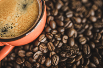 close up top view cup of coffee espresso on beans background