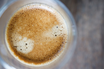 close up top view cup of coffee espresso with crema on wooden table