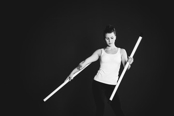 Juggler girl on black background, woman training  