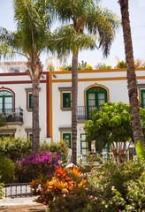 Gran Canaria, Spain - Typical architecture of Puerto de Mogan, a small fishing port of Gran Canaria. Colorfull flowers blooming around houses.