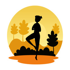 silhouette of woman practicing pilates on the landscape sunset scene