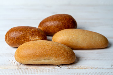 rye and wheat baguettes on white wooden table