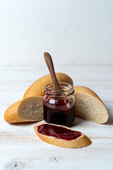 pieces white mini baguette with raspberry jam. Sweet snack.