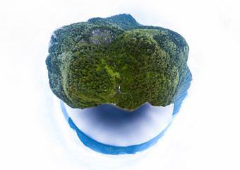 Abstract image of an island with green trees and mountains near the ocean or lake in Altai mountains in the form of a globe, planet or head