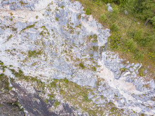 landscape of the valley of a mountain hill flooded with light and covered with large stones of different shapes with moss of green yellow and brown, rock space, a fresh summer day under the blue sky