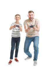 Fototapeta premium Portrait of father and son playing video game on white background