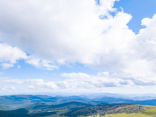 Blue sky with white clouds in mountains in summer