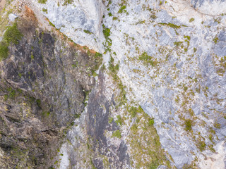 landscape of the valley of a mountain hill flooded with light and covered with large stones of different shapes with moss of green yellow and brown, rock space, a fresh summer day under the blue sky