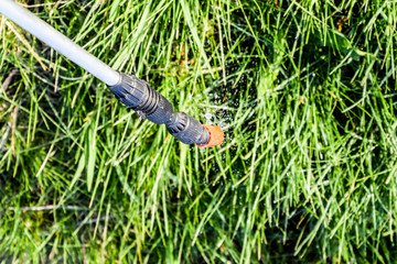 Spraying herbicide from the nozzle of the sprayer manual