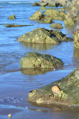 Rocks in blue seawater in patter or interval .