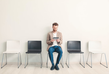 Young man waiting for job interview indoors