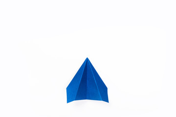 Blue paper airplane isolated on white background. top view