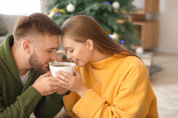 Young couple drinking hot chocolate at home