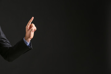 Fototapeta premium Hand of businessman on dark background