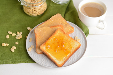 Plate with tasty toasted bread and jam on white table