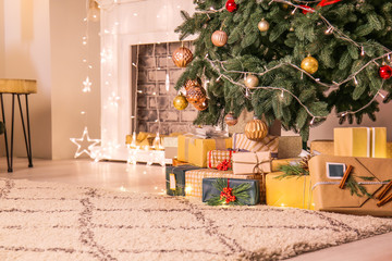 Fototapeta Many gift boxes under Christmas tree in room obraz