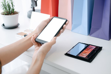 Mockup image of Beautiful woman shopping online with smartphone on online websites, mockup concept