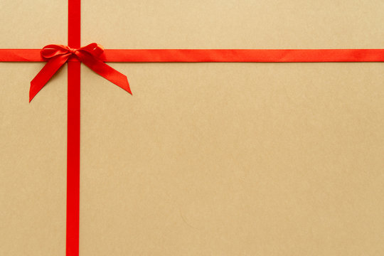 Christmas gift composition with red ribbin and bow. Flat lay, top view