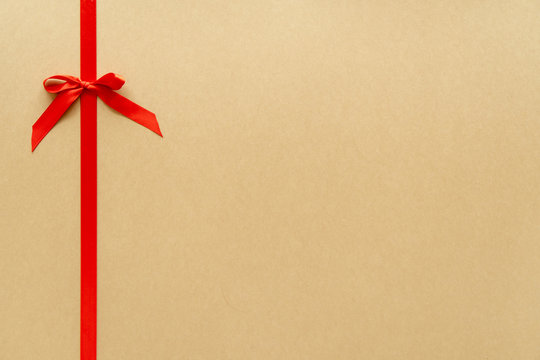 Christmas gift composition with red ribbin and bow. Flat lay, top view