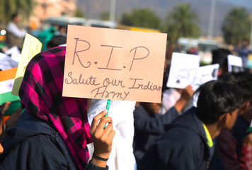 Close-Up of school kid holding rest in piece board in hand for indian army - Image