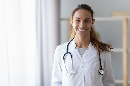 Smiling young female doctor wear medical uniform with stethoscope, portrait