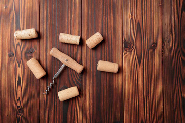 Corkscrew with cork. On a wooden background. - Image