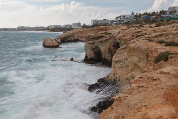 Fototapeta na wymiar Rocky shore of Cyprus with waves crashing