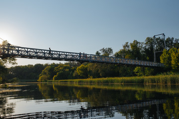 Bridge on river in sunset lights.