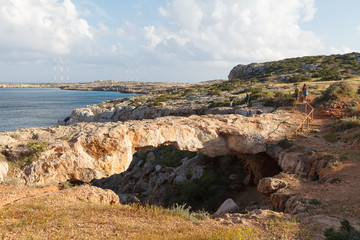 Natural bridge of lovers (Cape Greko, Cyprus, near Ayia Napa) at sunset.
