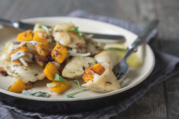 Ravioli, pelmeni, dumplings, pierogi, with pumpkin and fried onions