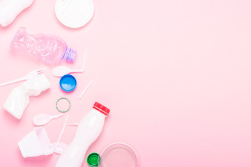 Garbage collection, plastic on a pink background. Concept stop plastic, recycling, separate collection of garbage. Flat lay, top view