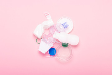Garbage collection, plastic on a pink background. Concept stop plastic, recycling, separate collection of garbage. Flat lay, top view