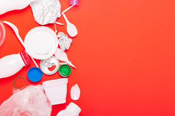 Garbage collection, plastic and metal on a red background. Concept stop plastic, recycling,...