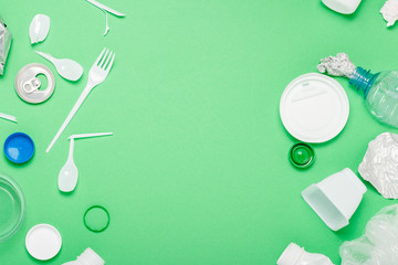 Garbage collection, plastic and metal on a green background. Concept stop plastic, recycling,...