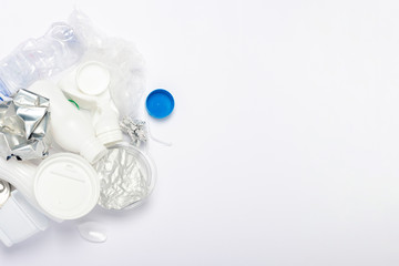 Garbage collection, plastic and metal on a white background. Concept stop plastic, recycling, separate collection of garbage. Flat lay, top view