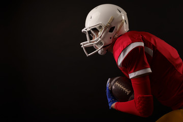 Image of running sportswoman with rugby ball, in helmet
