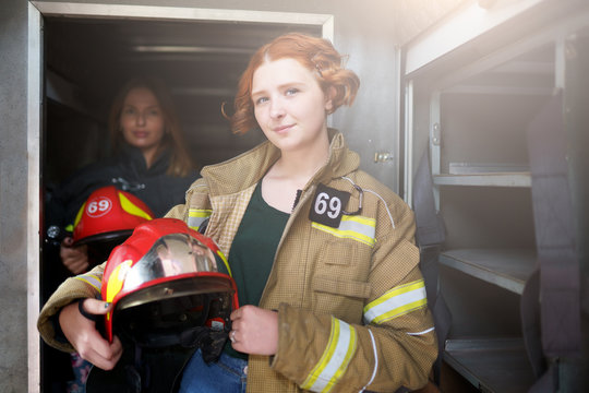 Image of two female firefighters in fire truck