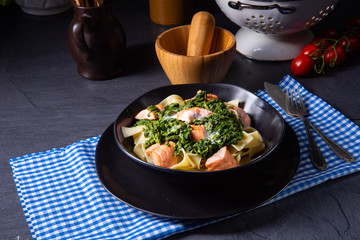 pappardelle pasta with creamed spinach and fried salmon