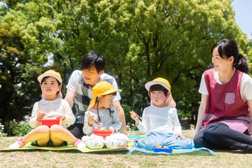 公園でお弁当を食べる園児